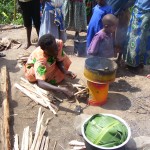 An African woman cooks using a fuel-efficient cookstove.